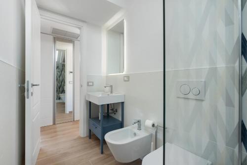 a white bathroom with a sink and a mirror at Residence Sulla Costa in Agerola