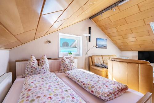 a small bedroom with a bed and a chair at Alte Schmiede in Kuden