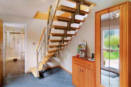 a spiral staircase in a home with a bathroom at Ferienwohnung Härtel in Bad Zwischenahn