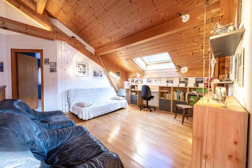 a living room with a couch and a table at chalet pierre et bois in Aigueblanche