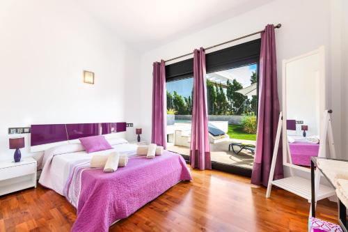 a white bedroom with purple curtains and a bed at Villa La Primera in Llucmajor