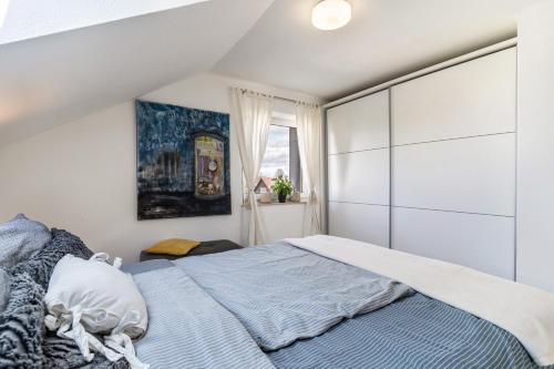 a bedroom with a large bed with blue sheets at Ferienwohnung Romanu in Winzeln