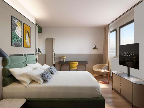 a hotel room with a bed and a television at Mercure Milano Agrate Brianza in Agrate Brianza
