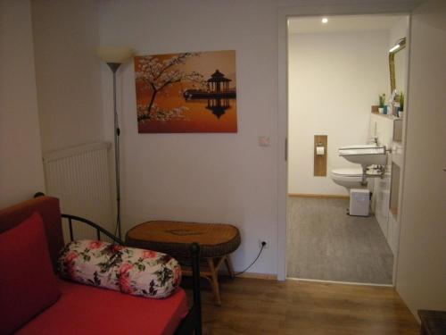 a small bathroom with a toilet and a sink at Rhön Residence in Dipperz