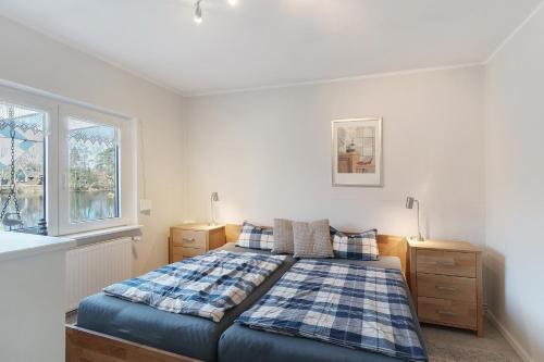 a bedroom with a bed and a window at Idyllic Lakeside Cottage in Bockhorn