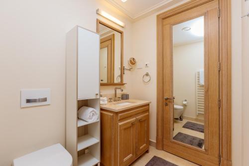 a bathroom with a sink and a mirror at Porto Montenegro Luxury Experience in Tivat