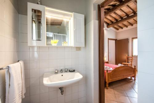 a bathroom with a sink and a mirror at Faetino - Gallo in Colle di Val d'Elsa