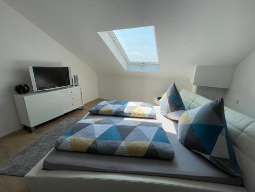 a living room with two beds and a television at Hegaublick in Stockach