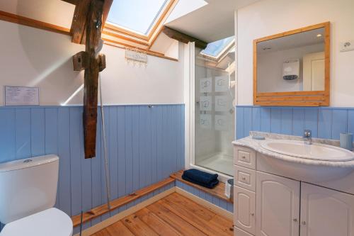 a bathroom with a sink and a toilet and a shower at Domaine de Lestroué - Île d'arz in La Vraie-Croix