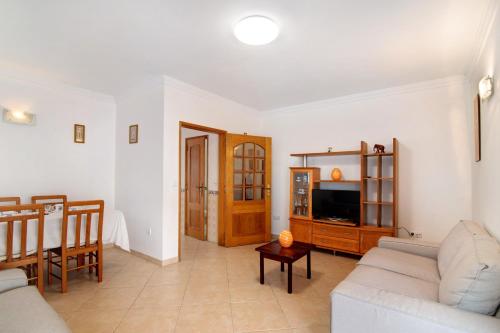 a living room with a couch and a tv at Moradia Altura in Altura
