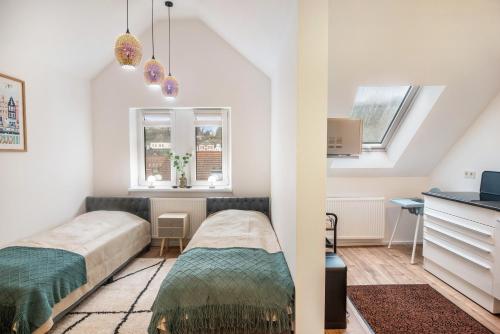 two beds in a small room with two windows at Ferienwohnung Maxim in Saarburg