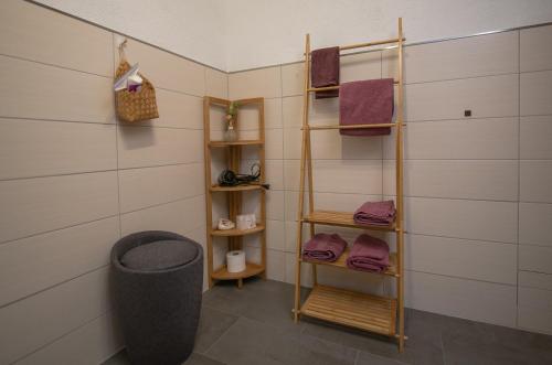 a bathroom with a towel rack and purple towels at Scheidegg unterm Kreuzberg in Scheidegg