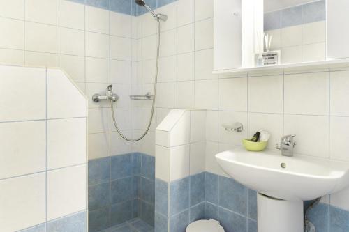 a bathroom with a shower and a toilet and a sink at The Castle House Kea in Ioulis