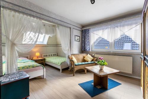 a bedroom with two beds and a couch and a table at Erholung Pur in Hennstedt