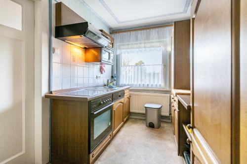 a small kitchen with a sink and a stove at Erholung Pur in Hennstedt