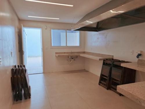 an empty kitchen with a counter and a sink at Quinta da Praia in Serra