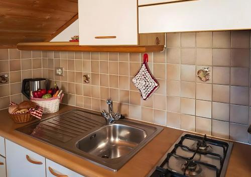 a kitchen with a sink and a stove at Lechnerhof Appartement Alpenrose in Schenna