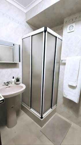 a bathroom with a shower and a sink at Ocean and River Torreira in Torreira
