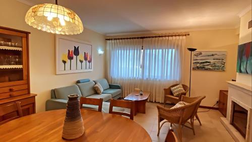 a living room with a couch and a table at Ocean and River Torreira in Torreira