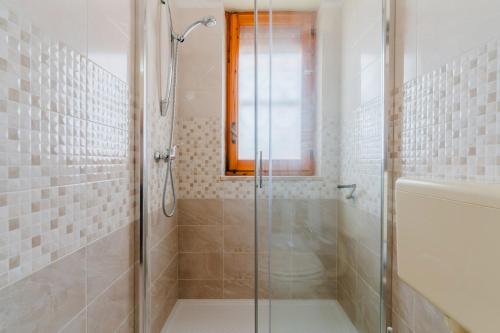a shower with a glass door in a bathroom at Alice's house in Otranto