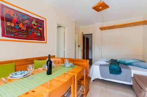 a living room with a bed and a table with wine glasses at Alice's house in Otranto