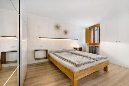 a bedroom with a bed and a glass wall at Ciarii Holiday Homes in Tremosine Sul Garda