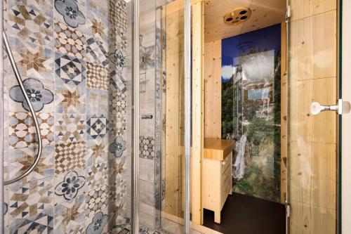 a shower with a glass door in a bathroom at Ciarii Holiday Homes in Tremosine Sul Garda