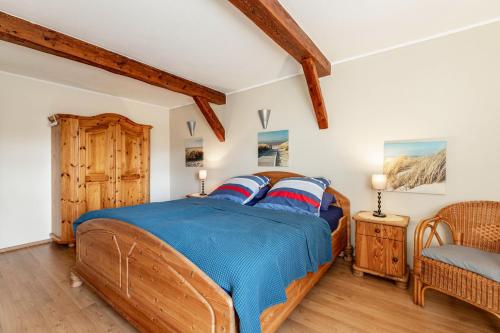 a bedroom with a wooden bed and a chair at Ferienwohnung Obenauf in Oesterwurth