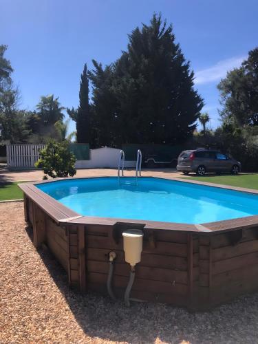 a pool with a hot tub in a backyard at Baobab Moz Lodge in Adail