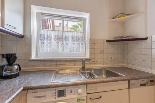 a kitchen with a sink and a window at Stricker in Markelfingen