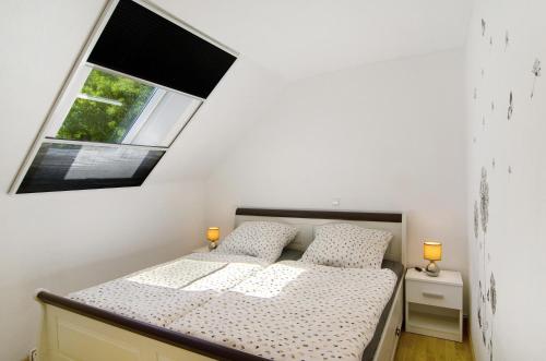 a small bedroom with a bed and a window at Ferienwohnung Otte in Apen