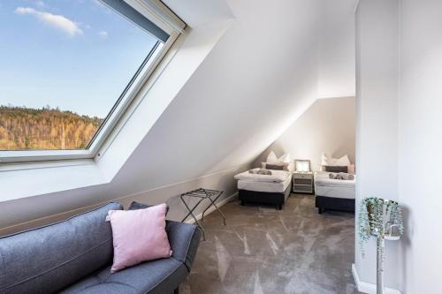 a living room with a couch and two beds at Fewo Schmallenberger Mauerblümchen in Schmallenberg