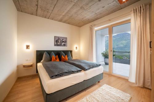 a bedroom with a large bed and a large window at Apartment Das Runde in Cermes