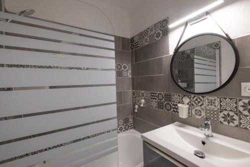 a bathroom with a sink and a mirror at Les chalets du Praz 4 - Immoclean in Morillon