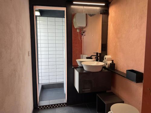 a bathroom with two sinks and a mirror at Ferienwohnung Teehaus in Saal