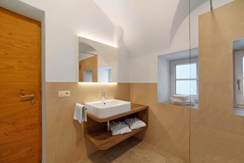a bathroom with a sink and a mirror at Engel Appartements Goschtstub in Parcines