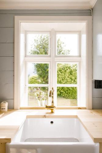 a kitchen with a sink and a window at Aarvik organic farm & bakery in Tveit