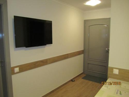 a room with a flat screen tv on the wall at Villa Shafaly in Mariánské Lázně