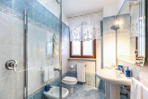 a bathroom with a toilet and a sink and a shower at L'antica Lugana front lake in Sirmione