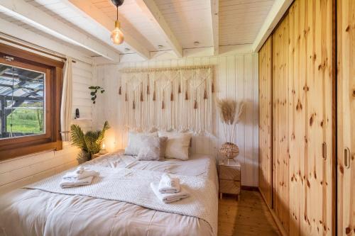 a bedroom with a bed with towels on it at Almhütte in Ulrichstein