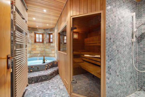 a bathroom with a tub and a walk in shower at Ferienwohnung am Steinbach in Albstadt
