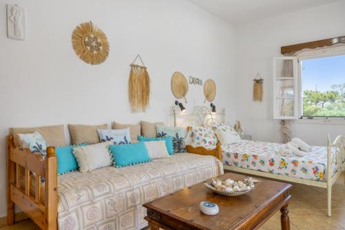 a living room with a couch and a table at Studio Telendos in Telendos