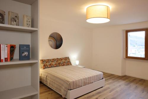 a bedroom with a bed and a window at Appartamento Torricelli in Fossombrone