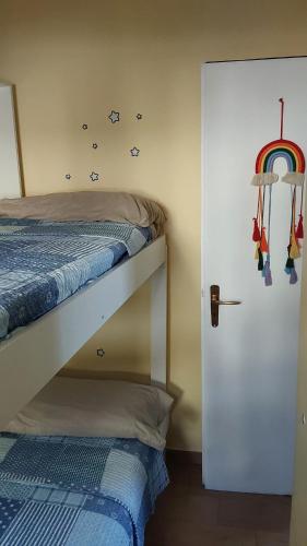 a bedroom with a bunk bed with a rainbow on the wall at La Dolce Vita - Apartment with shared pool and large terrace in Lido delle Nazioni