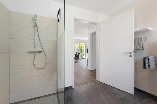 a bathroom with a shower and a glass door at Ostseerauschen in Hohwacht