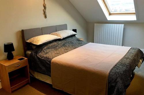 a bedroom with a large bed and a window at 6 Little Beach in Woolacombe