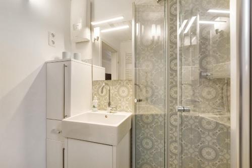 a white bathroom with a sink and a shower at Tiny House im Grünen in Jesberg