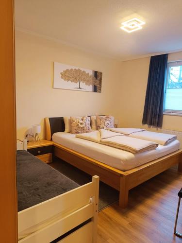 a bedroom with two beds and a window at Apart Bergtraum Ried - Typ 1 in Ried im Oberinntal
