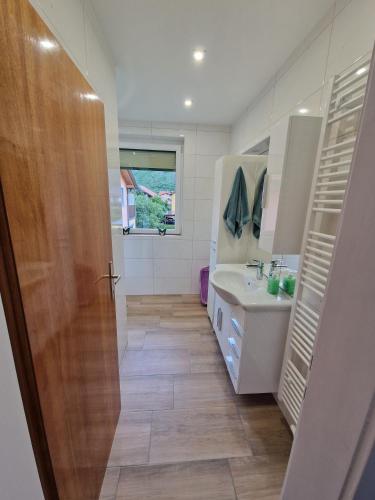 a bathroom with a toilet and a sink and a mirror at Haus Rose in Kaisersberg