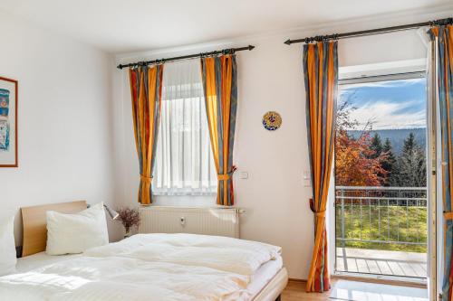 a bedroom with a bed and a large window at Ferienwohnung Tannenblick 1-1 in Oberhof